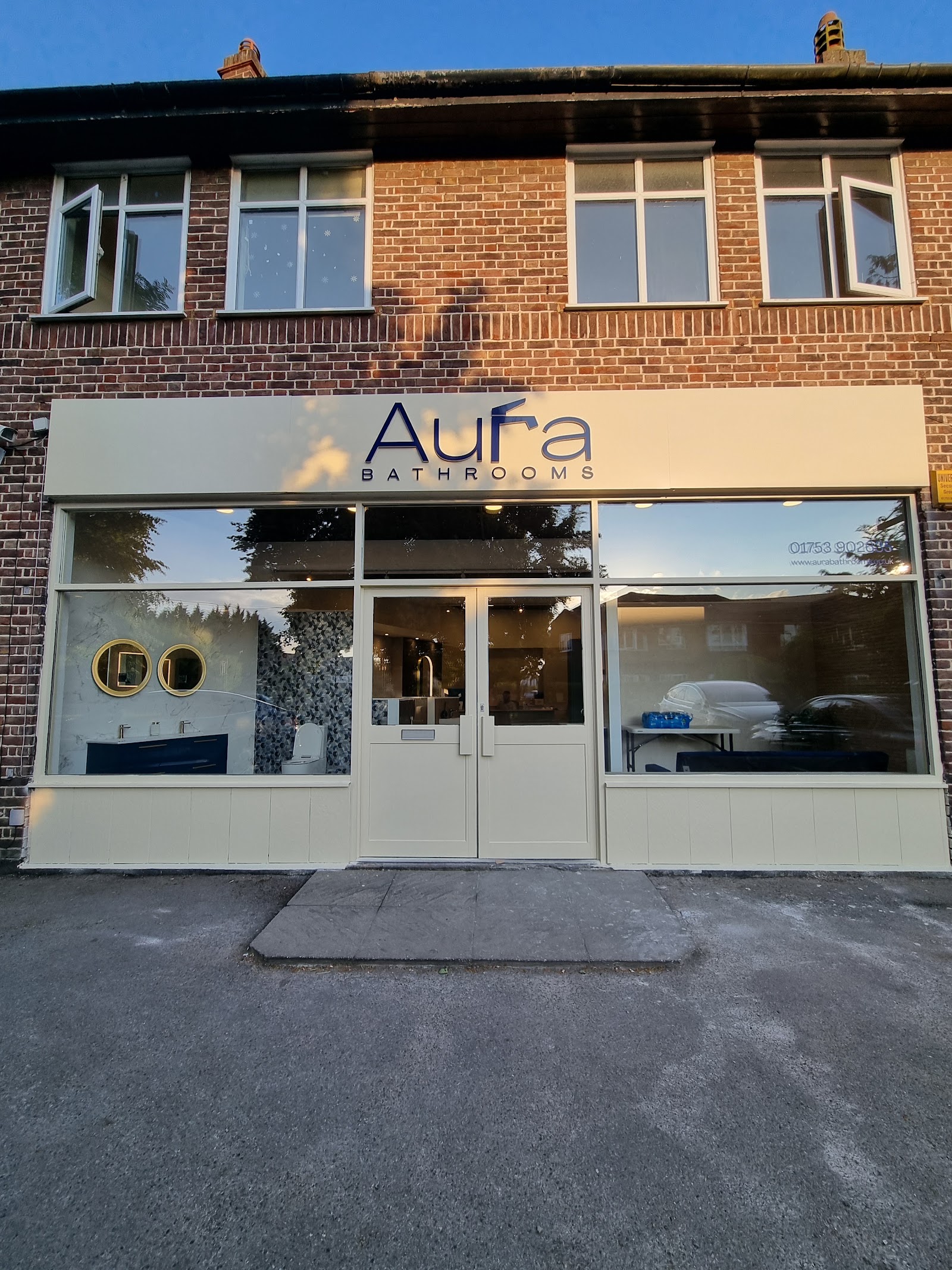 The Aura Bathrooms shopfront at Fulmer Corner, Gerrards Cross — displays visible through the glass from the Oxford Road.
